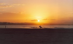 Surfers At Sunset