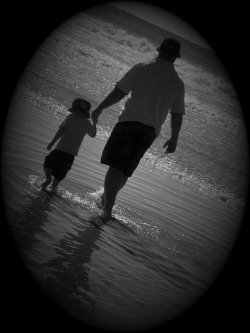 Father And Son Taking A Stroll On The Beach